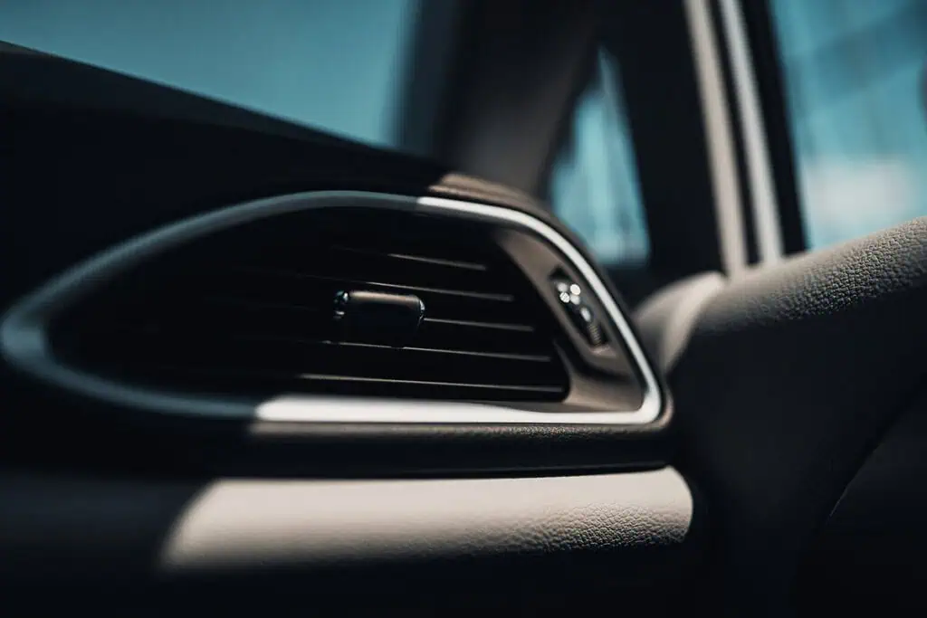 Close-up of a car air vent showing interior climate control features.